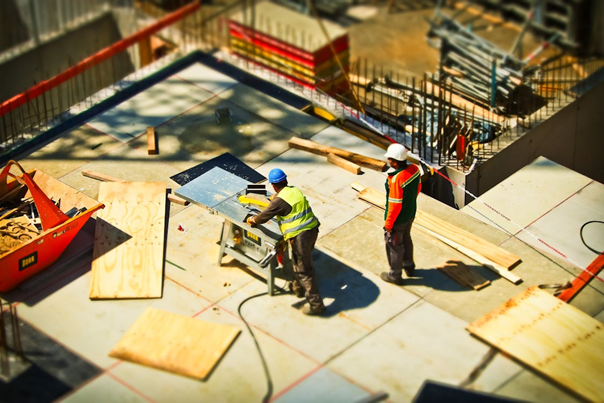 Two people working on a construction site 