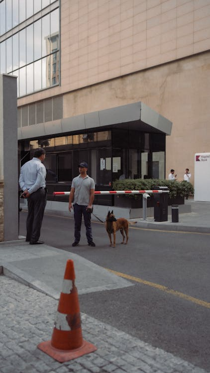 a security guard talking to a tenant near the security check of the apartment complex