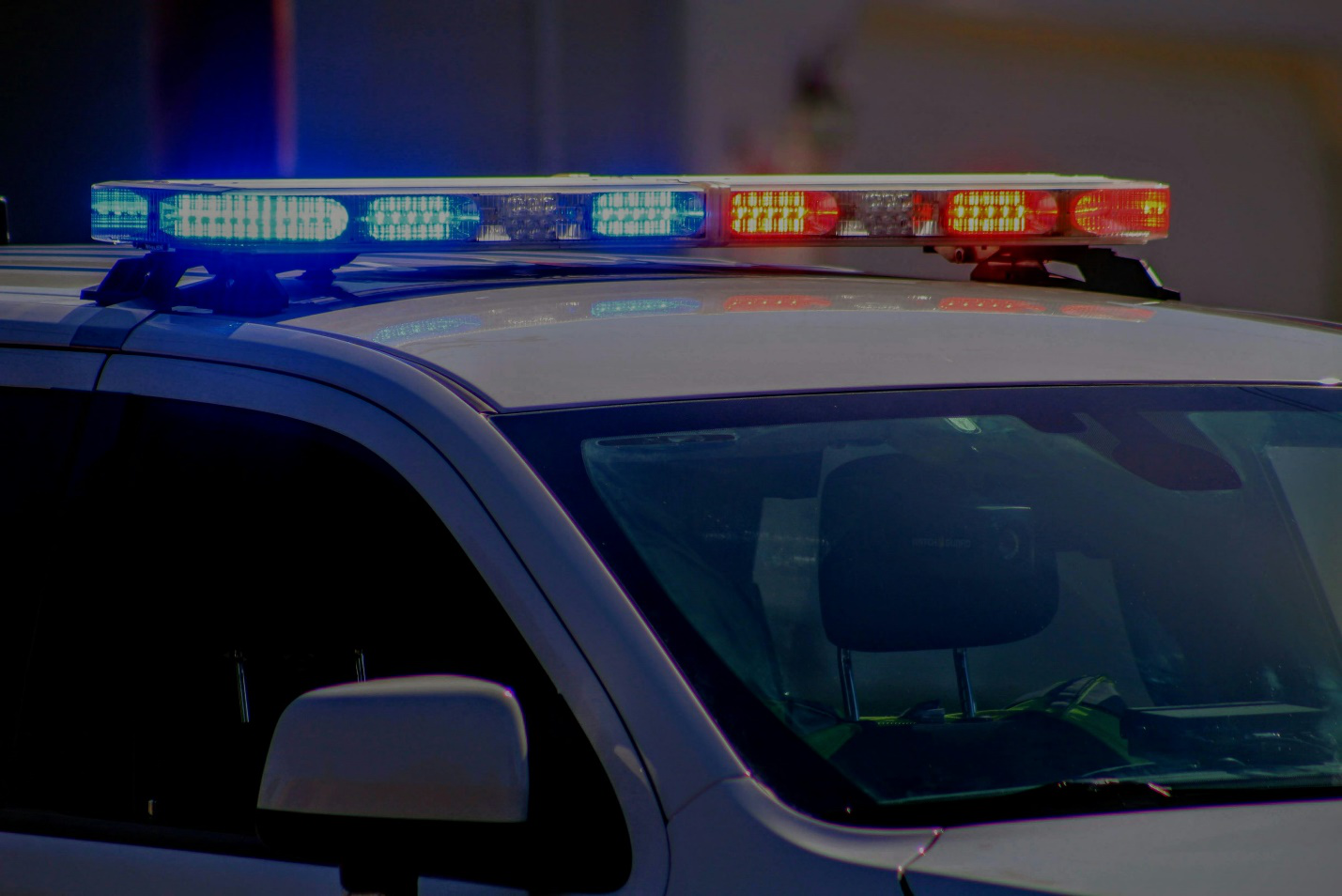Security patrol vehicle driving through a residential area