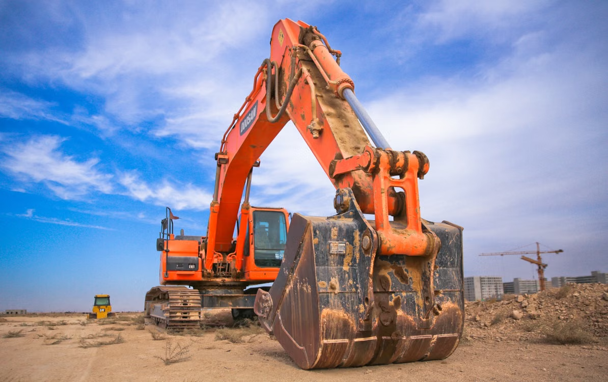  Heavy construction machinery parked at the end of the day during sunset.